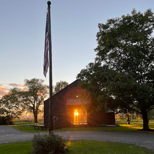 Beautiful view of rustic wedding venue during golden hour sunset.